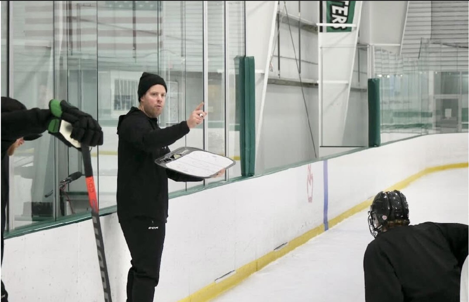 Quin Ryan coaching players on the ice