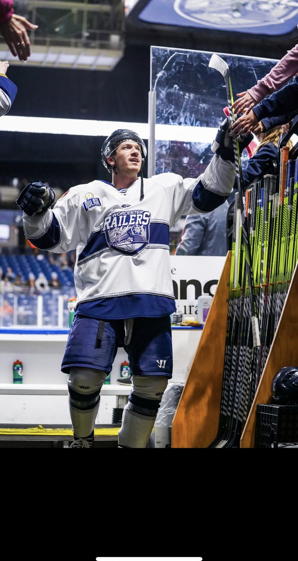 Player greeting young fans rinkside